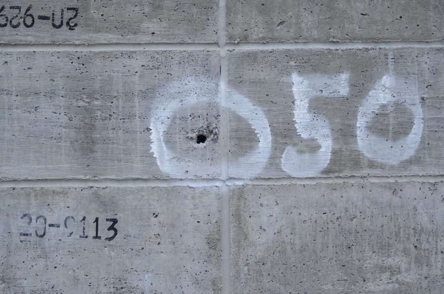 A .50 calibre impact point marked on an Amidon Shield test wall