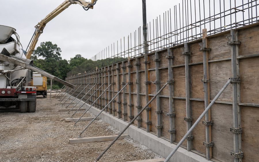 Concrete being placed into a reinforced wall form on site