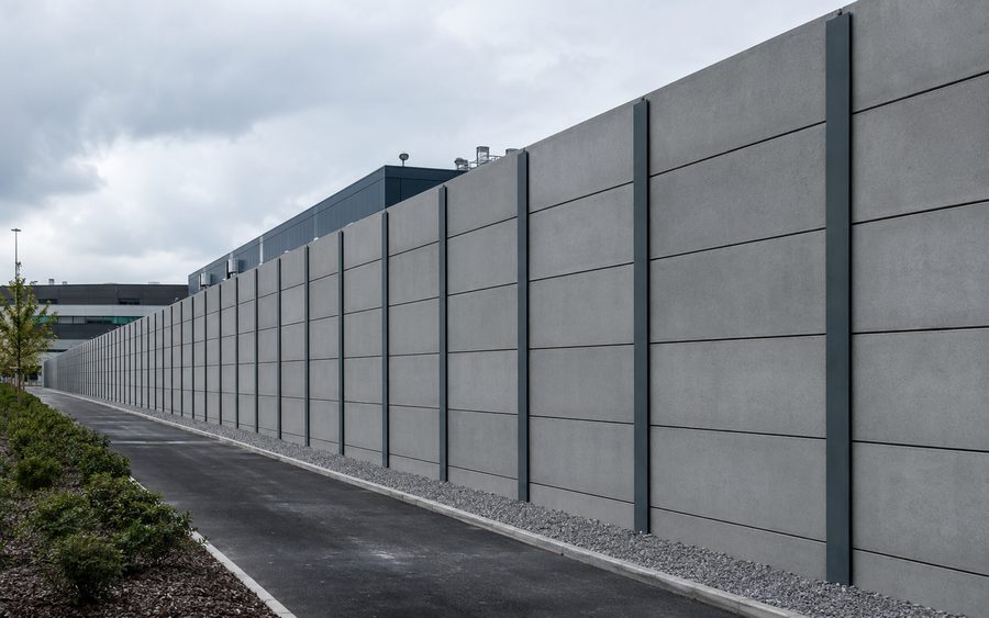 Precast concrete perimeter wall running the length of a secure compound